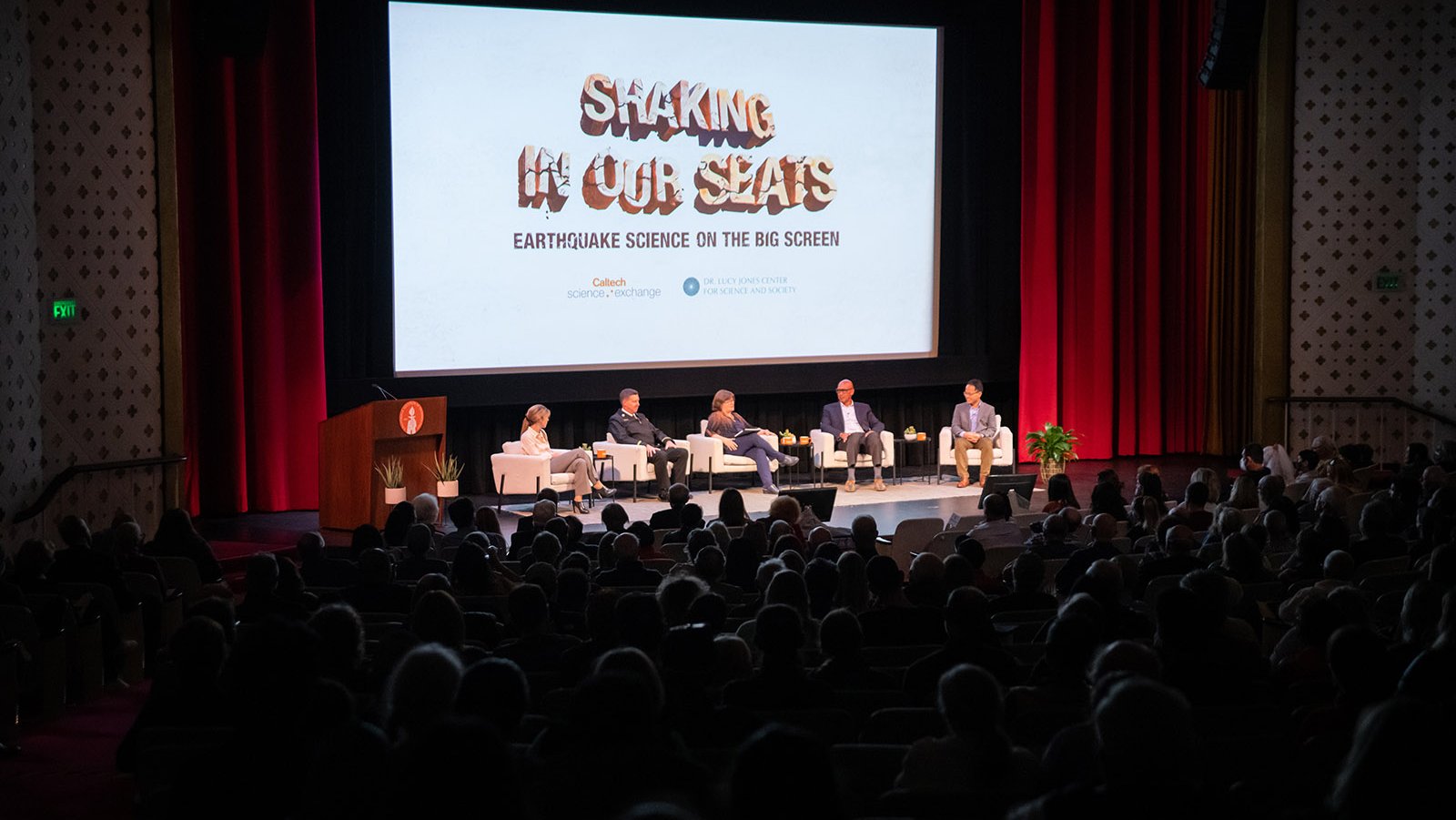 A photo of panelists on stage at Beckman Auditorium during the Seismo Centennial event