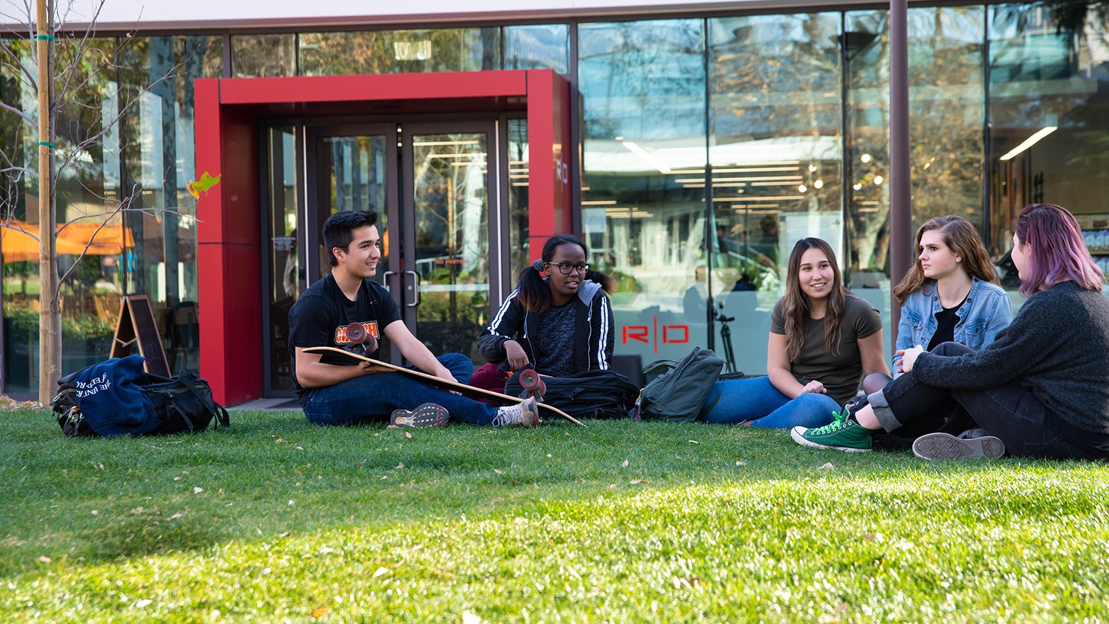A photo of a group of people on the lawn in front of the Red Door Cafe