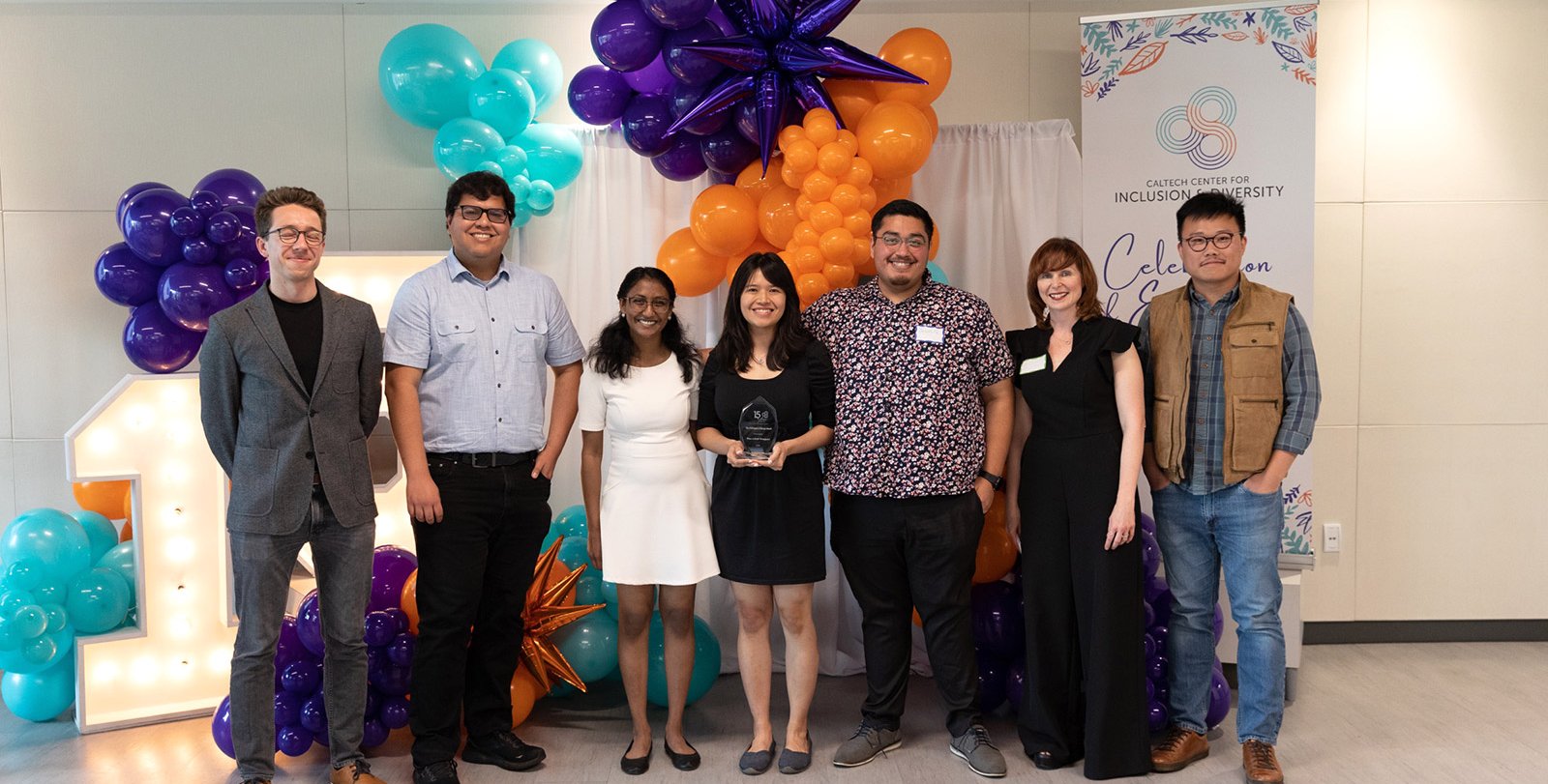 A group of seven people smiling into the camera