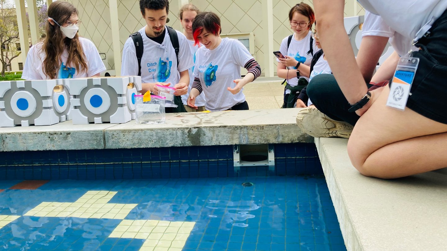 A group participating in a Portal-themed stack do an activity at the Gene Pool.