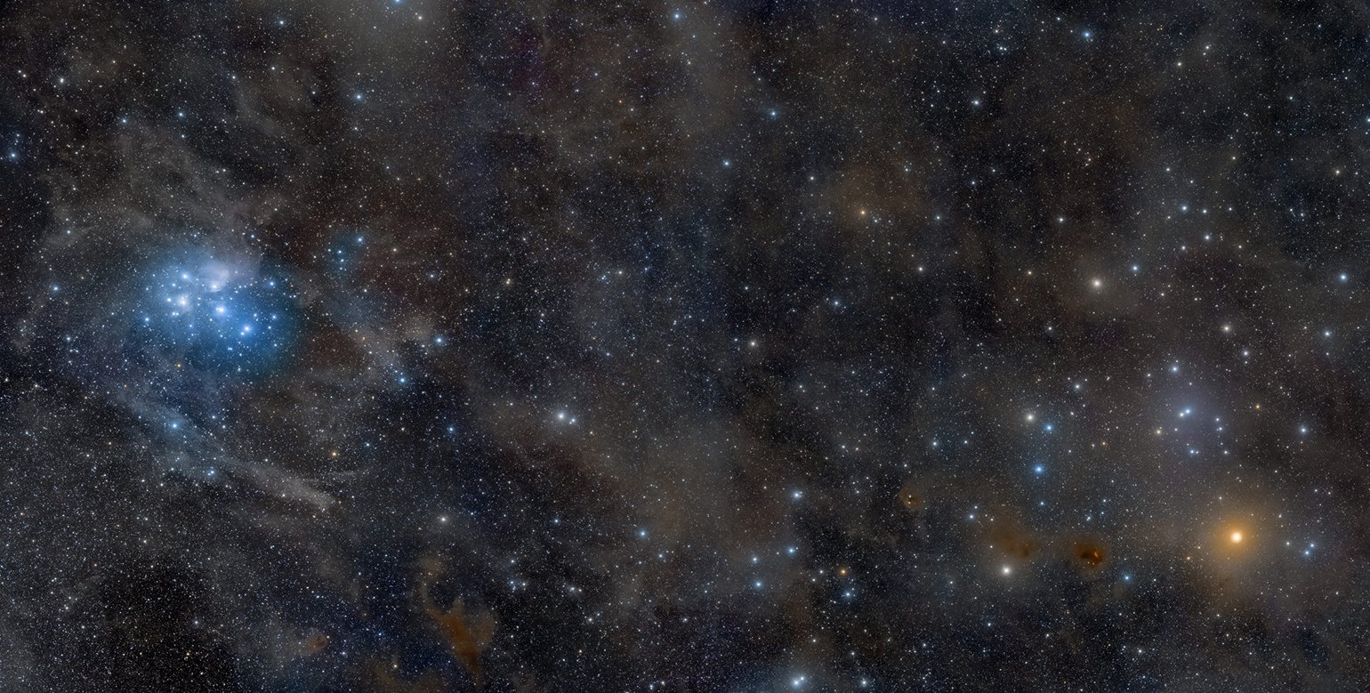 The night sky, showing the Pleiades, a collection of stars on the left center of the image, and the star Aldebaran on the lower right.