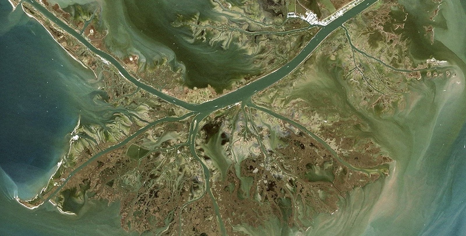picture of a river delta meeting the sea