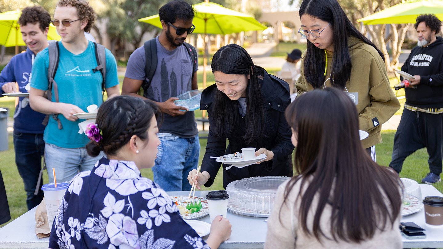 Attendees sample sushi from the Japan booth.
