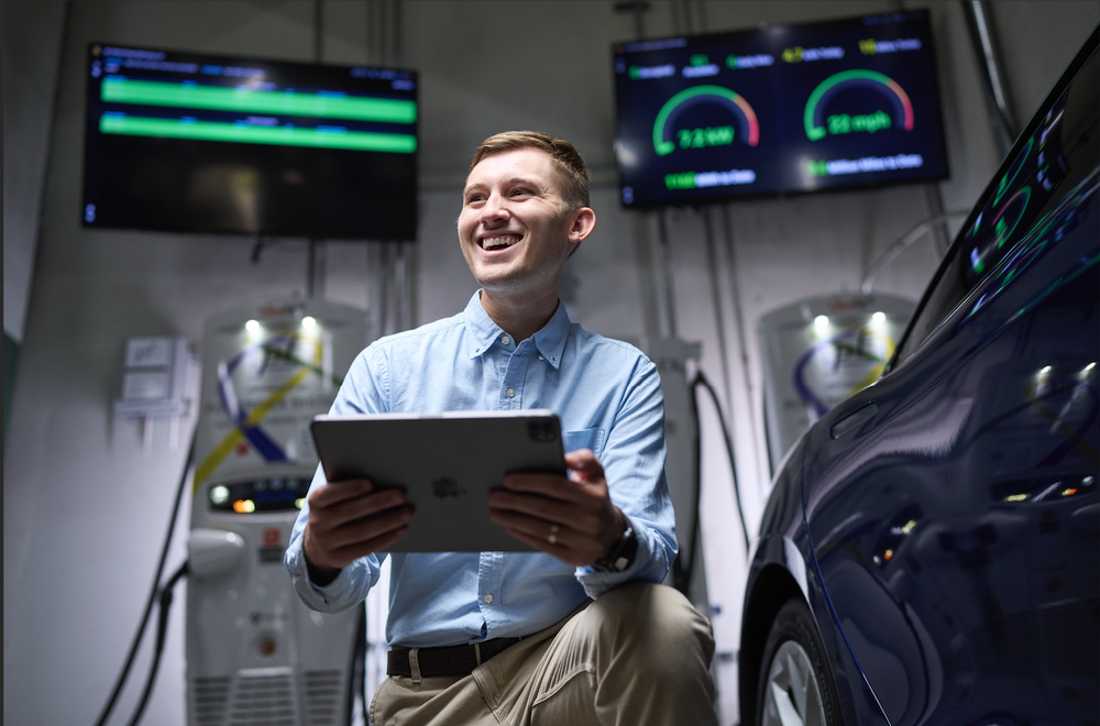 man with electric vehicle and charging station